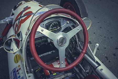 red and white racing car on gray raod thumbnail