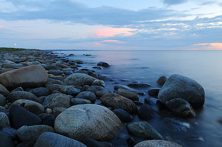time-lapse photography of rocky seashore during golden hour thumbnail