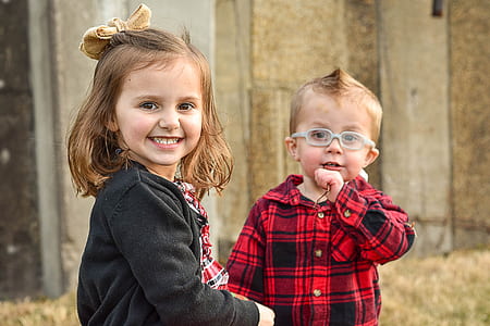 girl and boy standing on grass smiling thumbnail