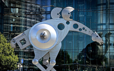 white metal horse statue near glass building during daytime thumbnail
