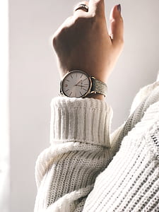 woman wearing round white analog watch with grey strap thumbnail