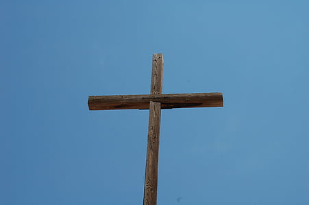 brown wooden cross under clear sky thumbnail