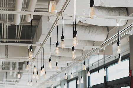 black pendant lights hanging on white steel ceiling frame thumbnail
