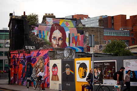 group of people walking on side of wall with graffiti thumbnail