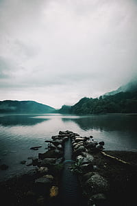 gray pipe and body of water at daytime thumbnail