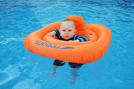 baby on orange Speedo inflatable buoy thumbnail