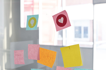 assorted-color stick notes pasted on clear glass wall thumbnail