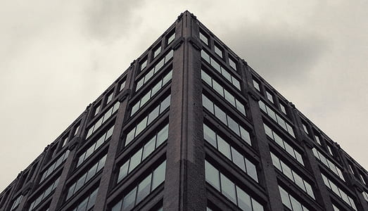 black concrete building with glass windows thumbnail