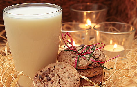 clear drinking glass filled with milk near candles thumbnail