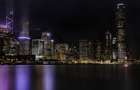 large body of water across city with high-rise buildings during nighttime thumbnail