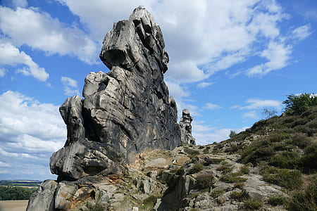 gray rock formation on hill under blue sky at daytime thumbnail