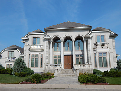 white concrete 2-story house under blue sky with white clouds during daytime thumbnail