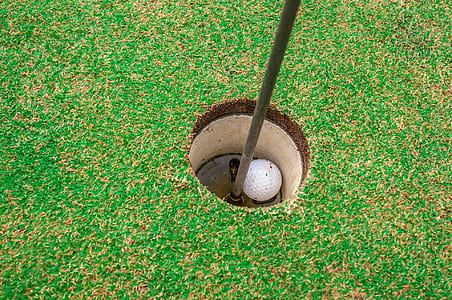 white golf ball on hole thumbnail