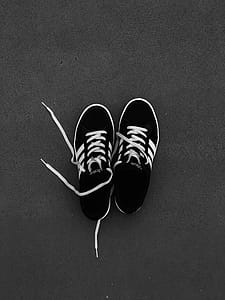 Pair of Black-and-white Adidas Sneakers on Grey Floor thumbnail