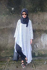 woman wearing Hijab with pants taking photo during day time thumbnail