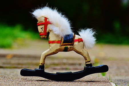 selective focus photograph of brown and black rocking horse thumbnail
