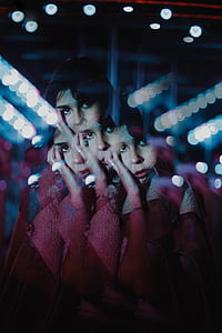 woman in red coat in mirror photography thumbnail