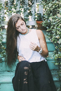 woman wearing white sleeveless top and black midi skirt thumbnail
