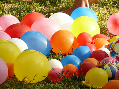 assorted-color balloons on green grass during daytime thumbnail