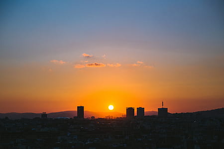 Colorful sky at sunset over a city thumbnail