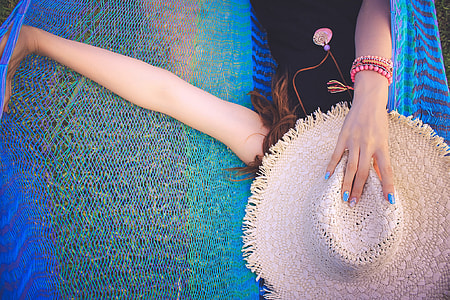 woman holding sun hat during daytime thumbnail