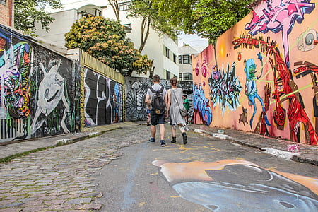 couple walking between murial wall thumbnail