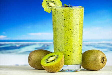 Kiwi Fruit Beside Drinking Glass Filled With Kiwi Shake thumbnail