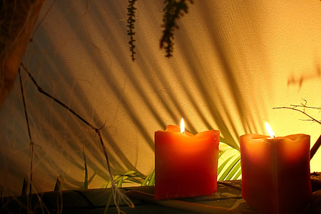 lighted two red candles near the white textile thumbnail