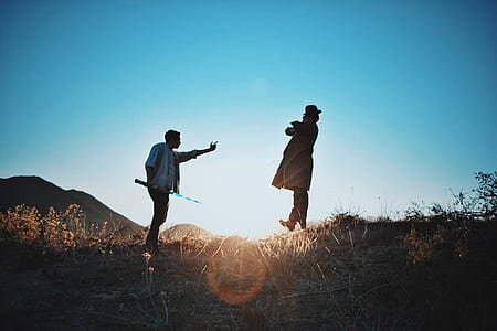 2 Man Standing on Mountain during Day Time thumbnail