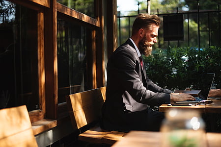 man in suit using laptop thumbnail