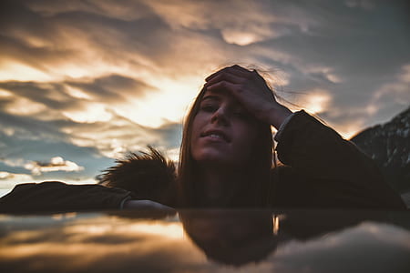woman holing forehead thumbnail