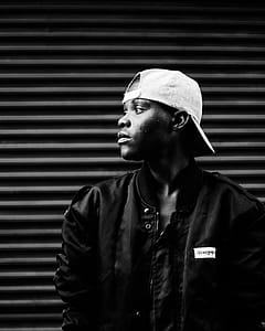 Greyscale Photography Of Man Wearing Cap thumbnail