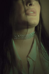 photo of woman wearing choker and beige top thumbnail