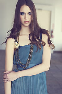 shallow focus photography of woman in blue sleeveless dress thumbnail