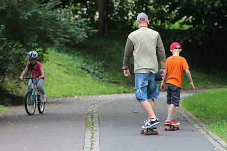 man and boy playing skateboards thumbnail