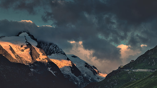 snow coated mountains under cloudy sky thumbnail