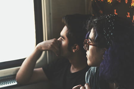 man and woman looking through window thumbnail