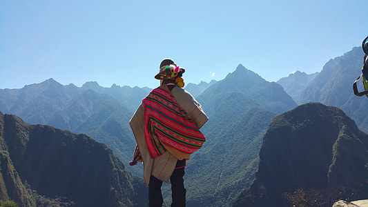 person standing beside mountain thumbnail