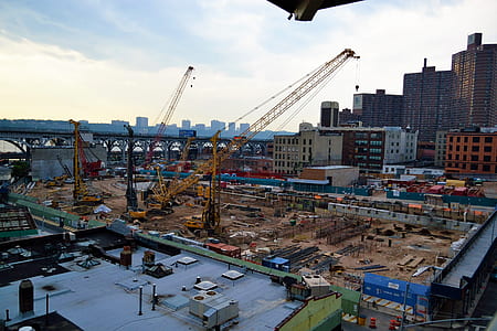 yellow truck crane near buildings thumbnail