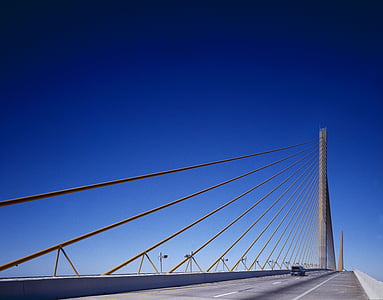 black vehicle on suspension bridge at daytime thumbnail