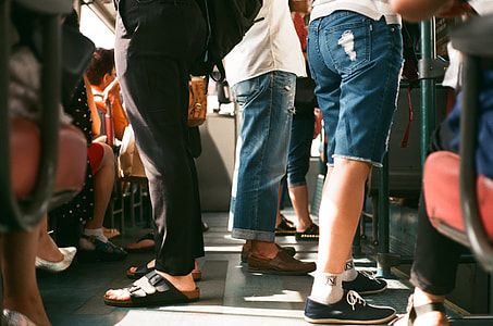 shallow focus photography of group of people riding on transport bus thumbnail