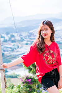 Woman Wearing Red Shirt Standing Beside a Post thumbnail