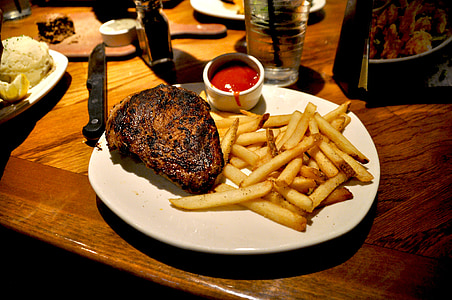 potato fries and beef steak on white ceramic plate thumbnail