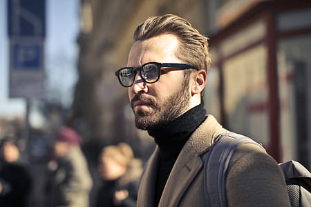 Selective Focus on young bearded male backpacker with backpack on his shoulders,waiting at the street thumbnail