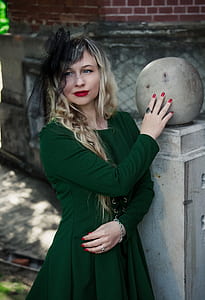 woman leaning on gray concrete pillar thumbnail