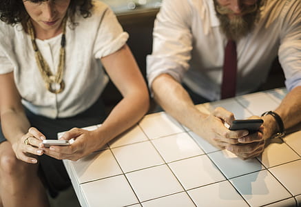 two woman and man sitting on chair while using phones thumbnail