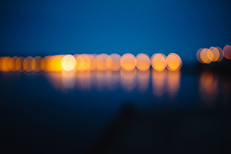 City lights reflected in the water at night thumbnail