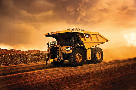 yellow Caterpillar haul truck on brown land during daytime thumbnail