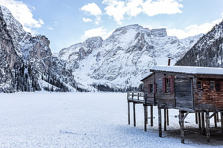 shack near mountain filled with snow thumbnail