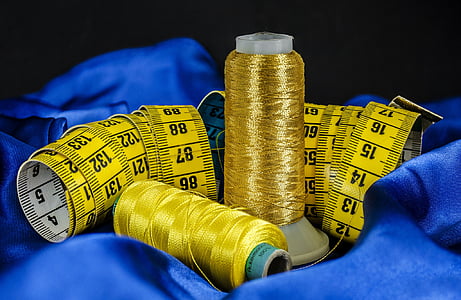 depth of field gold-colored and yellow threads beside tape measure thumbnail
